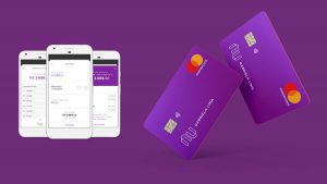 Cartões de crédito Nubank em um fundo roxo e, ao lado direito da imagem, três celulares que mostram o aplicativo do banco na área de transferência.