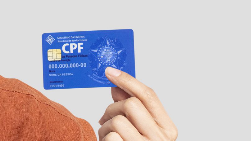 homem segurando o CPF na mão